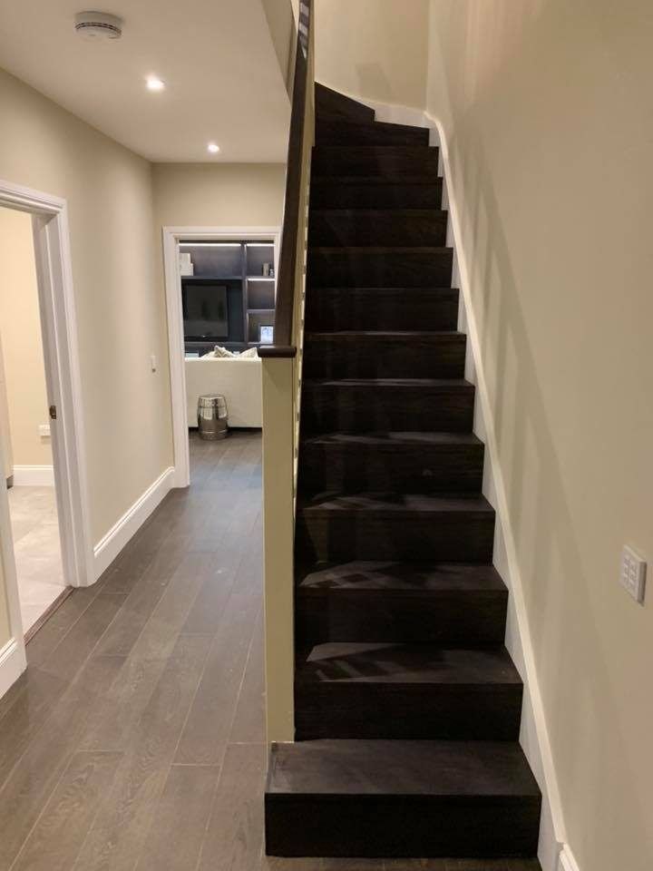 Straight staircase clad in dark stained timber
