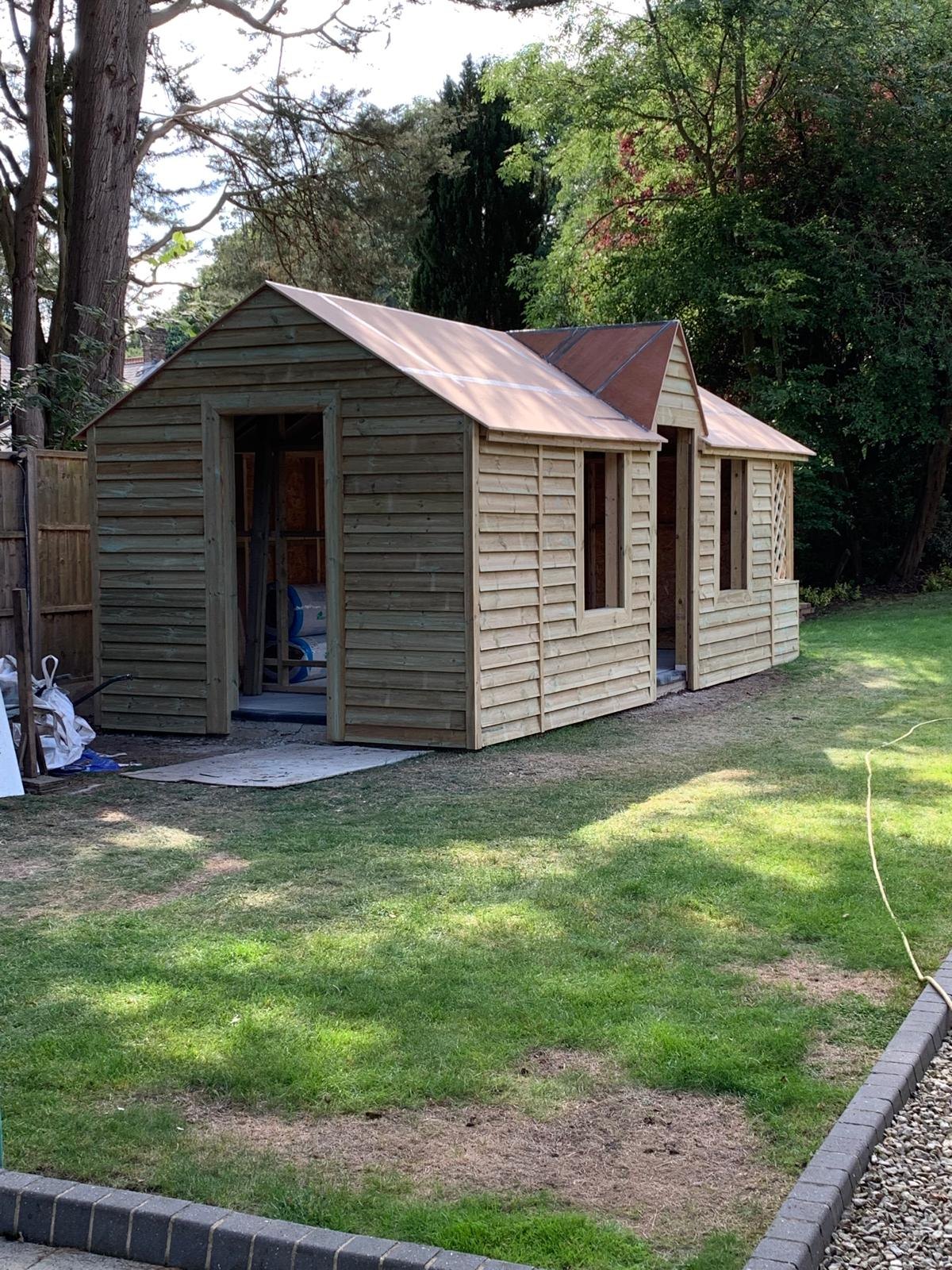 Timber clad garden building with a gabled roof