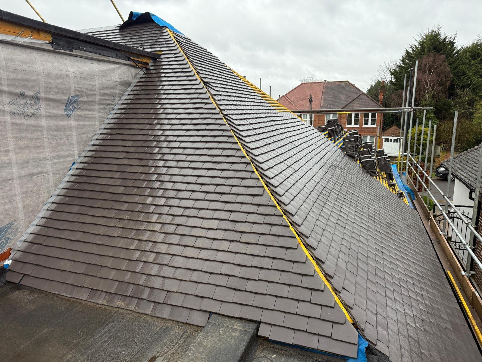 Hipped roof being retiled with new plain tiles